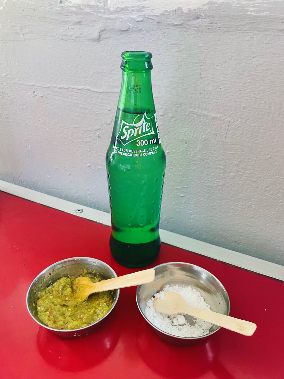 Mauritian green mazavaroo chili paste and salt and bottle of Sprite