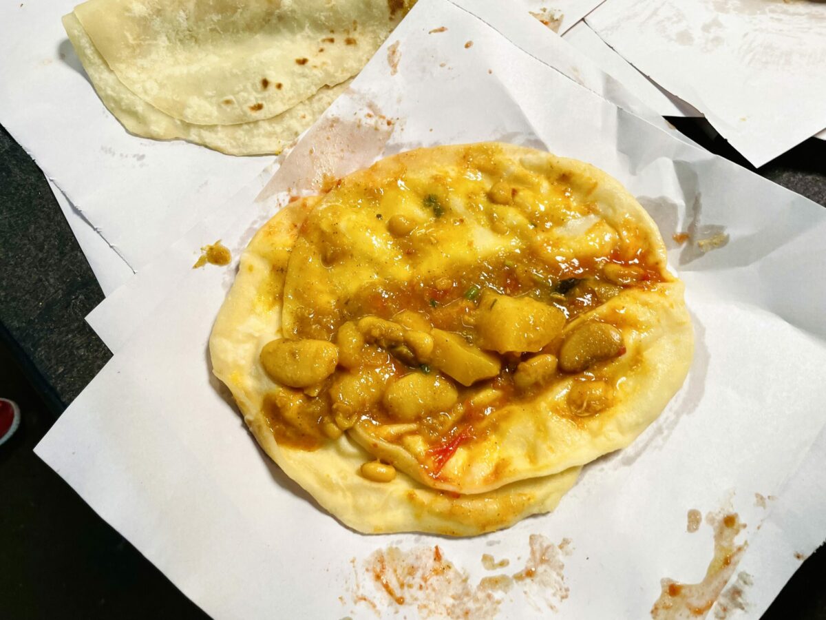 Open Mauritian dholl puri, dhal puri, from Chez Buy Vendor in Arab Town Rose Hill. Fillings are lima bean curry with potatoes and rougaille.