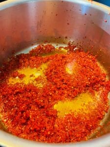 Mauritian Chinese red chili paste cooking in pot.