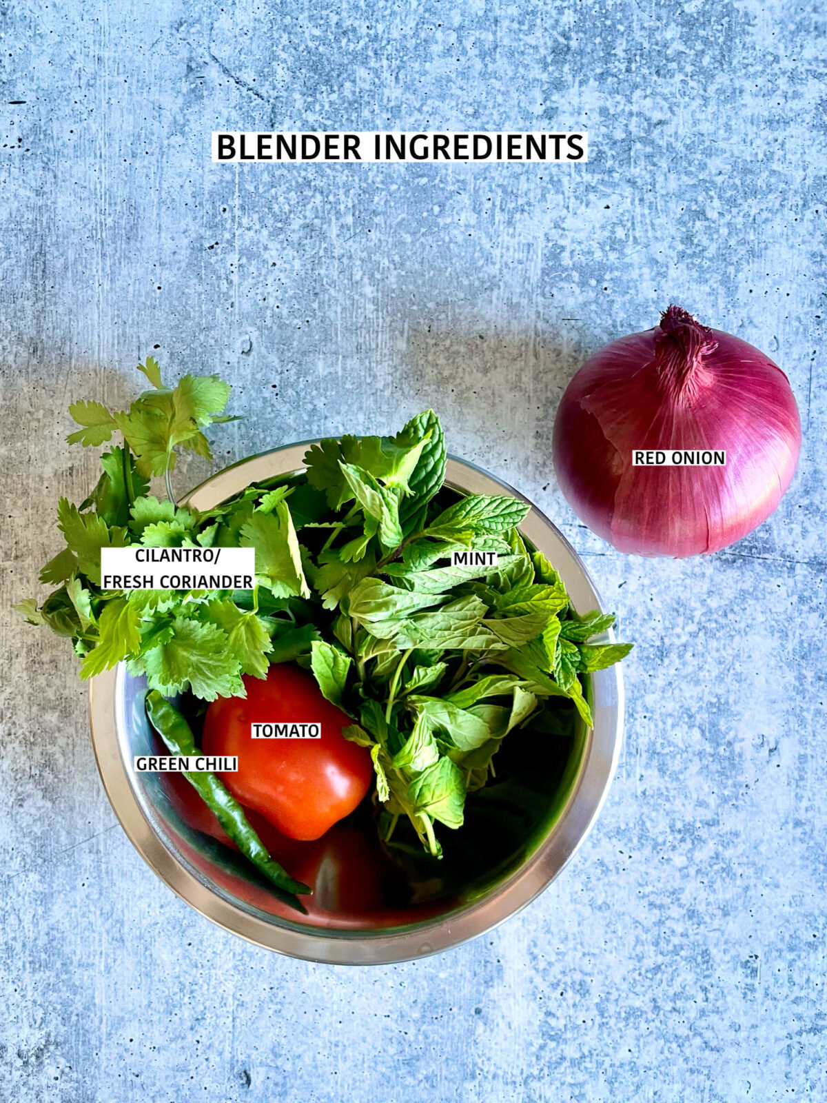 Blender ingredients for briani: cilantro/coriander, mint, roma tomatoes, green chilies and whole red onion.