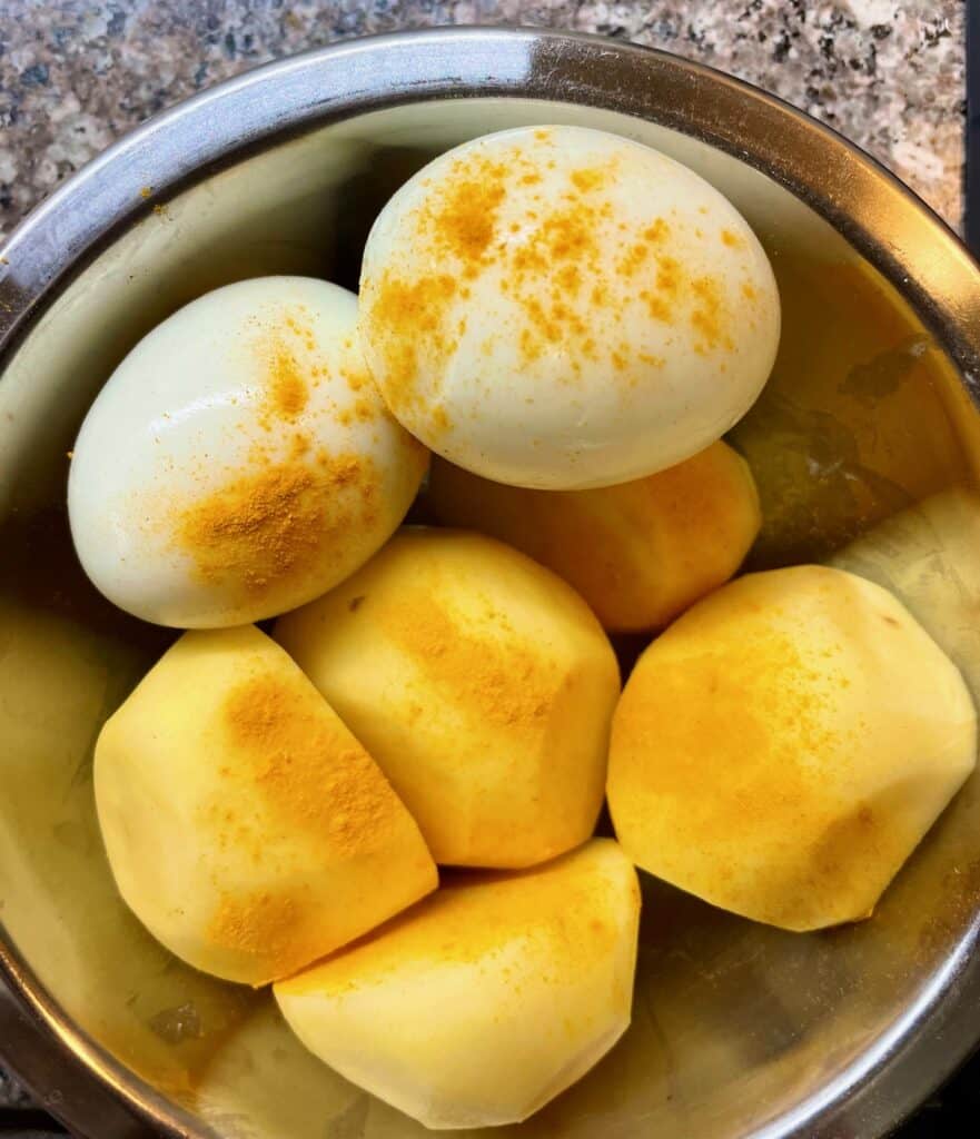 Hard-boiled eggs and potatoes topped with turmeric