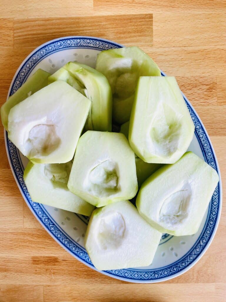 Peeled, halved and deseeded chayote or chouchou in Chinese oval plate.