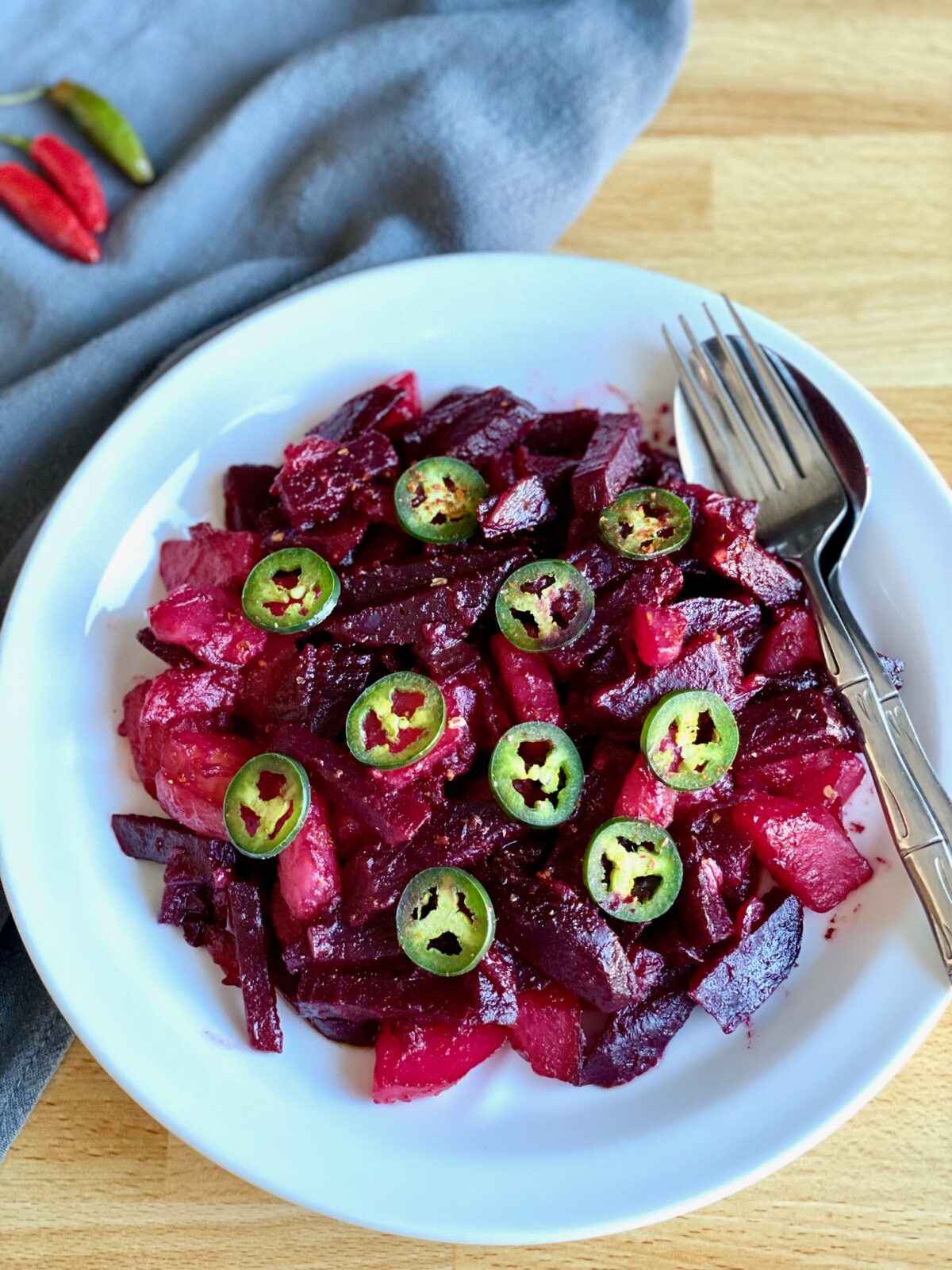 Ethiopian beet and potato salad with jalapeno on white plate.