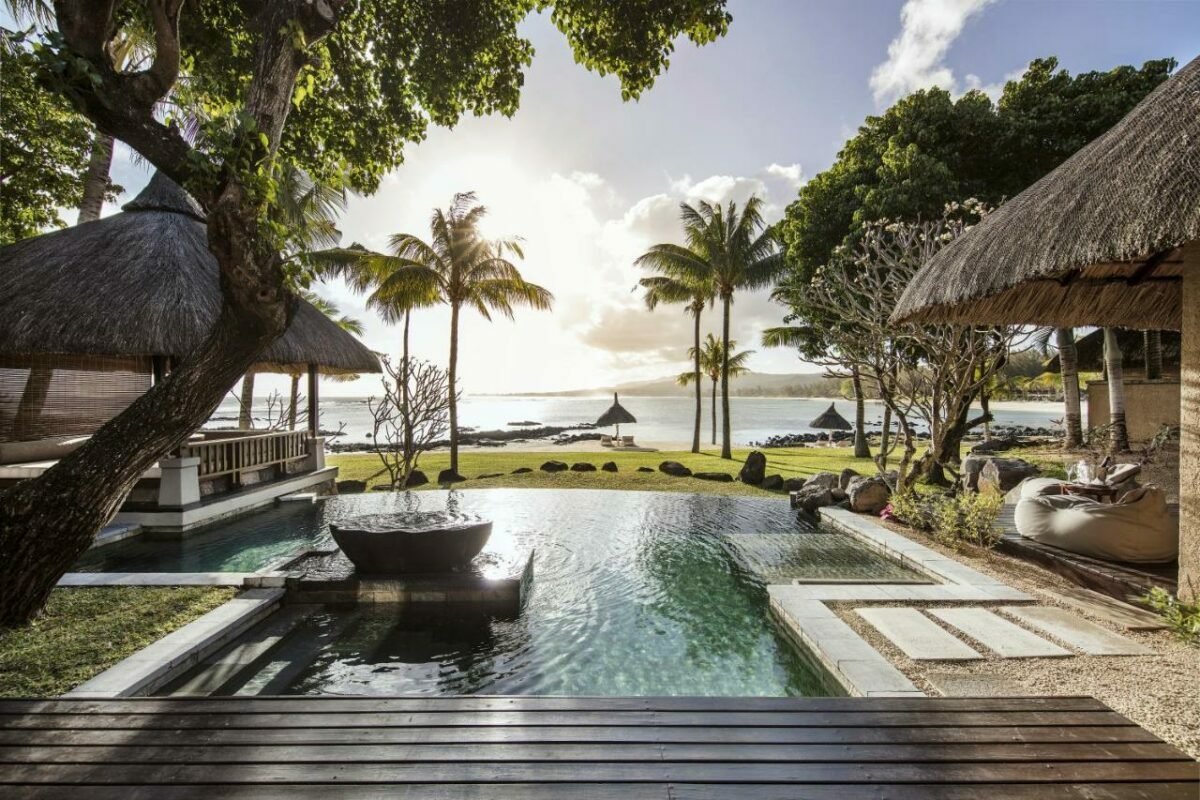Shanti Maurice Honeymoon resort in Mauritius, pool overlooking palm trees and the ocean.