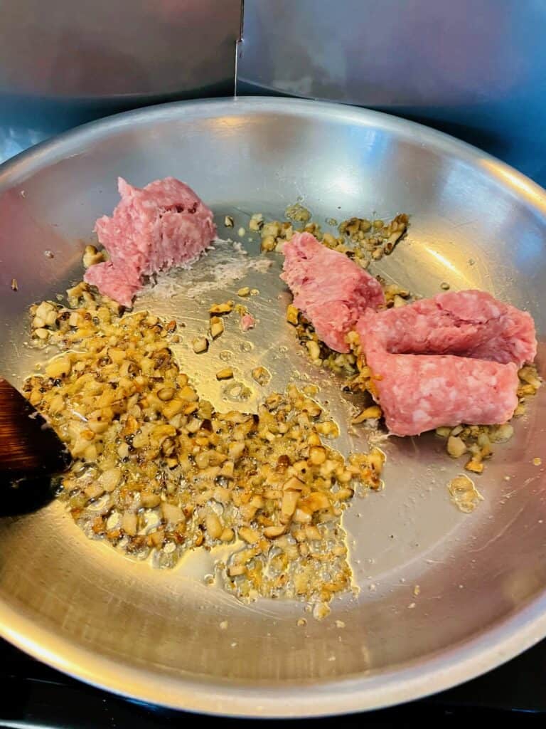 Minced dried shiitake, dried shrimp and ground chicken cooking in pan.